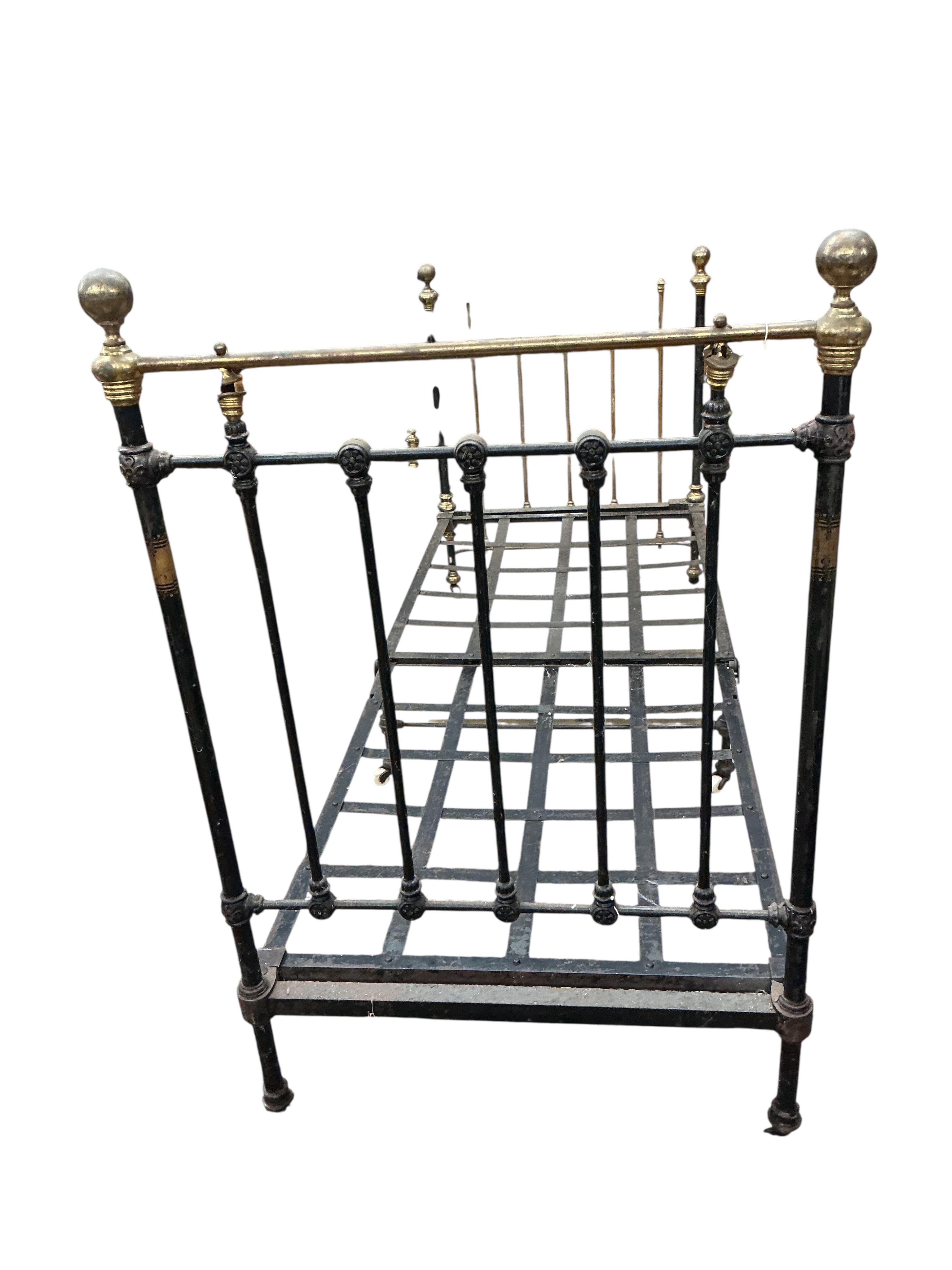 A pair of Victorian brass mounted cast iron single bed frames, each width 91cm, height 142cm